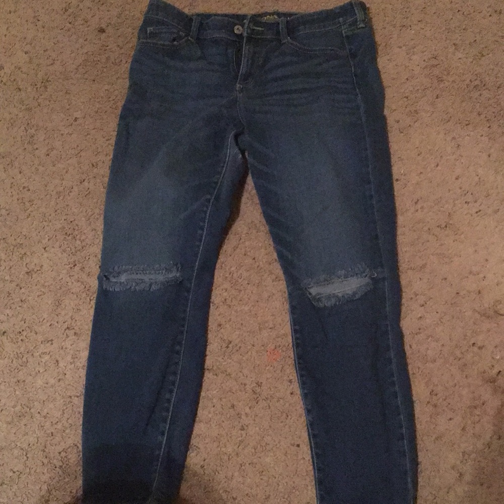 Blue jeans with rips at the knees